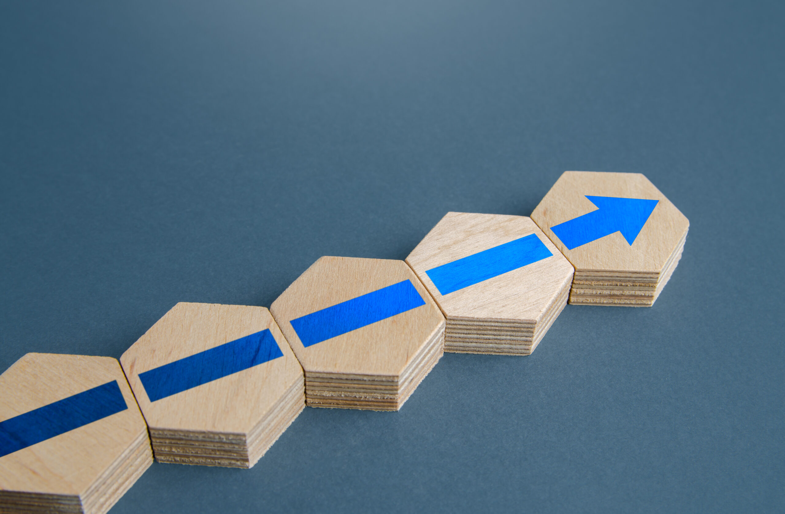 An additional block with an arrow to the existing assembly. Continuation of process, further progress. Moving forward, direction. Promotion at work. Development. Ensuring growth and expansion.